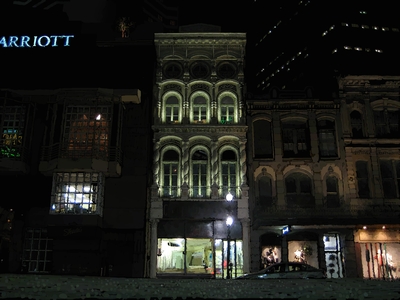 Architectural illustration of the Merchants Mutual Insurance Company at night in New Orleans.